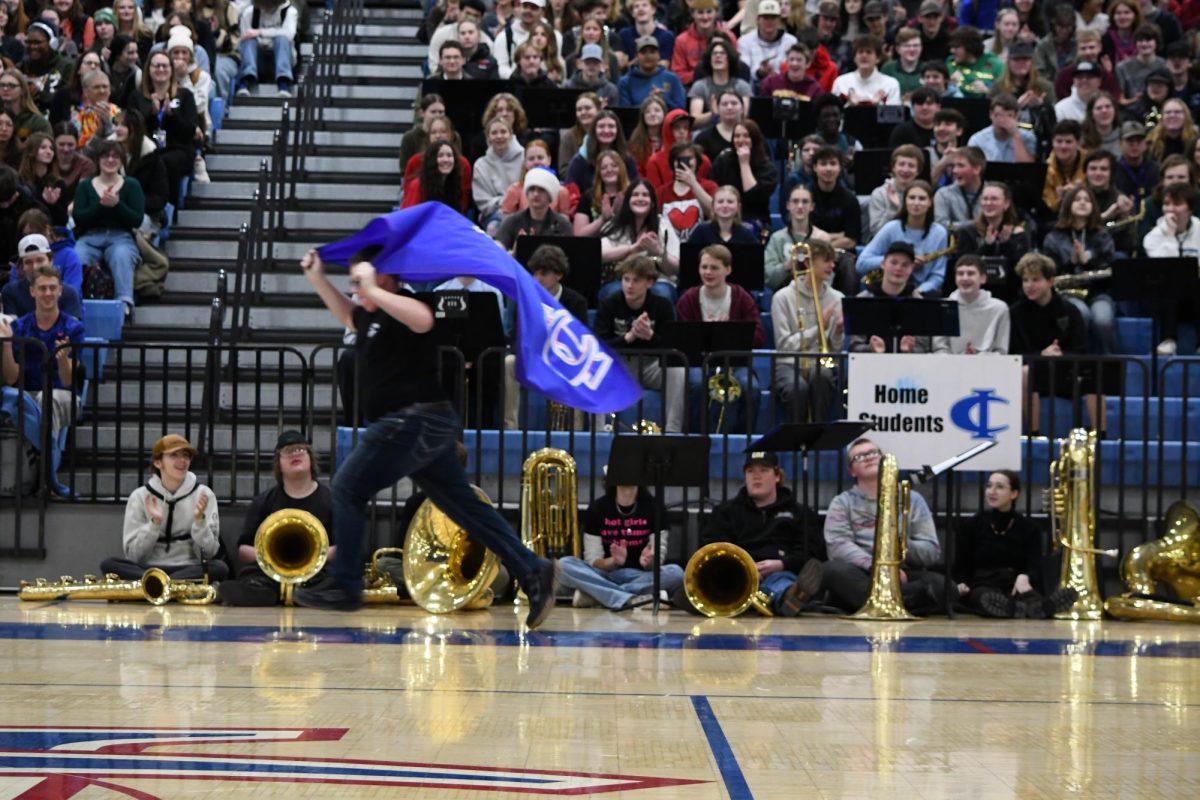 Evan "Student Council Man" Jorgenson revs up the crowd with a lap around the gym.
